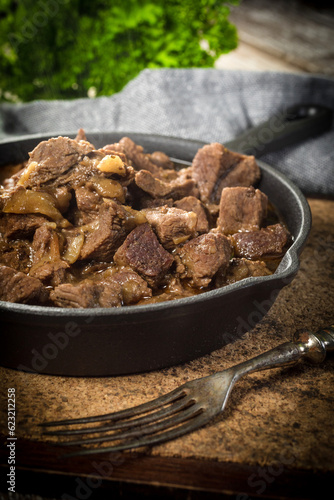 Beef stew in a cast iron skillet.