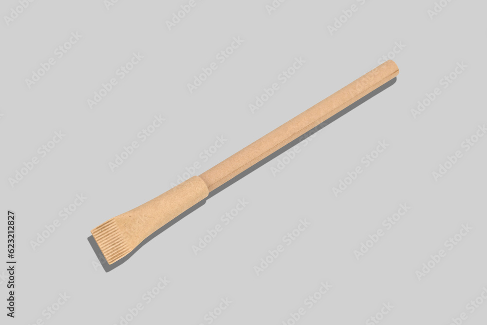 Pen made from environmental recycled paper on grey background. Mock up for branding. Eco concept. Pen made from environmental recycled paper on grey background. Mock up for branding. Eco concept.