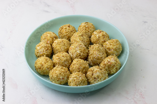 An appetizer for the festive table. Aperitif. Cheese balls in peanut crumbs