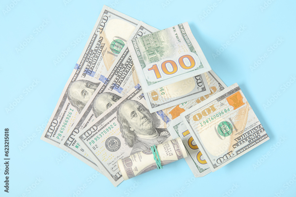 One hundred dollar banknotes on color background One hundred dollar banknotes on color background