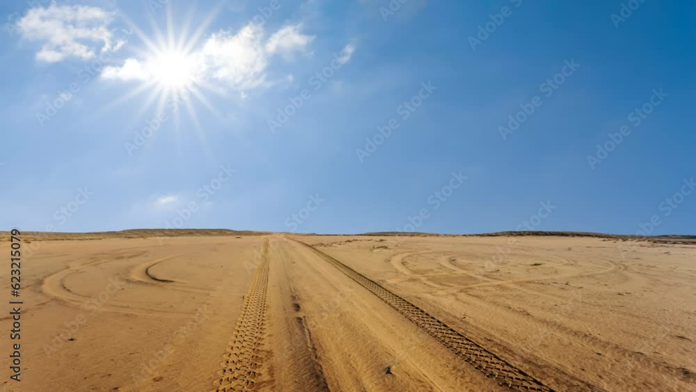 road through the sandy desert under a sparkle sun time lapse scene road through the sandy desert under a sparkle sun time lapse scene