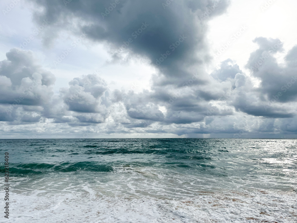 Empty Mai Khao beach in Thailand. Golden sand, deep blue water and moody monsoon clouds in the sky. Fantastic holiday destination. No people around. Wallpaper for inspiration and dreaming. Empty Mai Khao beach in Thailand. Golden sand, deep blue water and moody monsoon clouds in the sky. Fantastic holiday destination. No people around. Wallpaper for inspiration and dreaming.