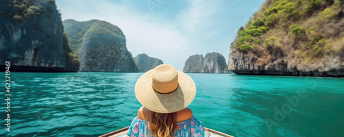 Rear view of young girl with hat and summer dres sitting on boat. copy space for text.