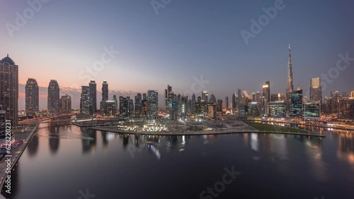 Wallpaper Mural Aerial panorama of Dubai Business Bay and Downtown with the various skyscrapers and towers along waterfront on canal day to night transition timelapse. Construction site with cranes after sunset Torontodigital.ca