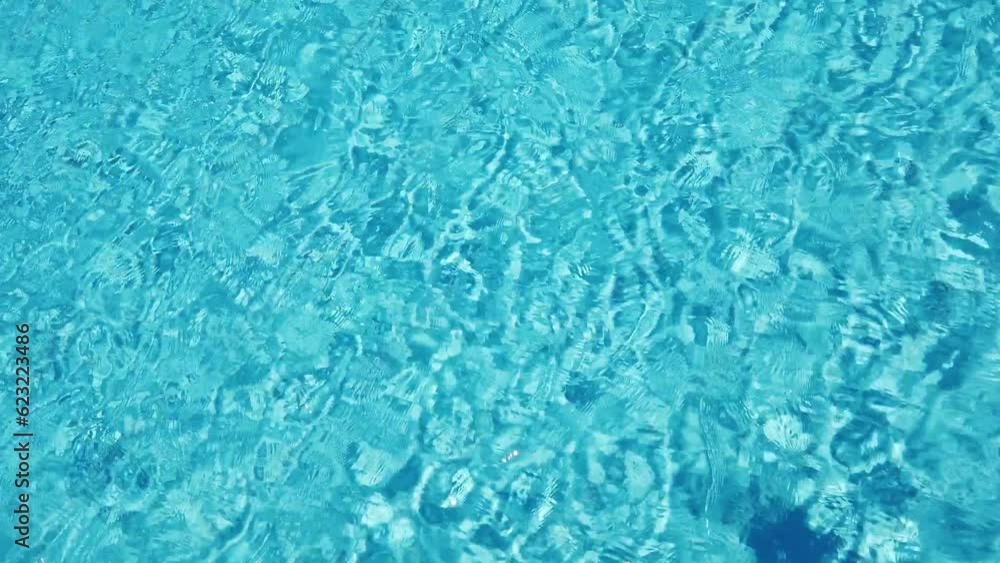 Top view of a Crystal Clear Swimming Pool with glittering sun rays and wave movement Top view of a Crystal Clear Swimming Pool with glittering sun rays and wave movement