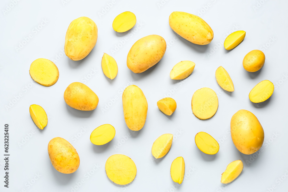 Whole and cut potatoes on blue background Whole and cut potatoes on blue background
