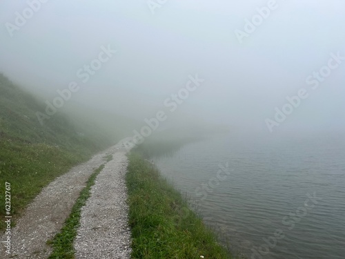 Gravel path leading into thick fog