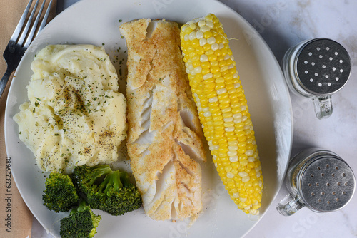 baked cod served with corn and mashed potatoes