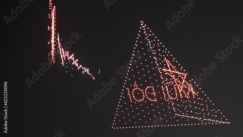 Shot of flying glowing drones creating 3d model of a triangle, Asian style, deep dark night sky, 4k