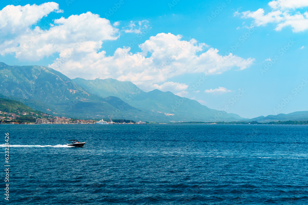 seascapes, a view of the Bay of Kotor during a cruise on a ship in Montenegro, a bright sunny day, mountains and small towns on the coast, the concept of a summer trip