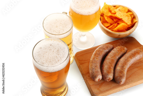 Glasses and mug of cold beer with different snacks on white background. Oktoberfest celebration