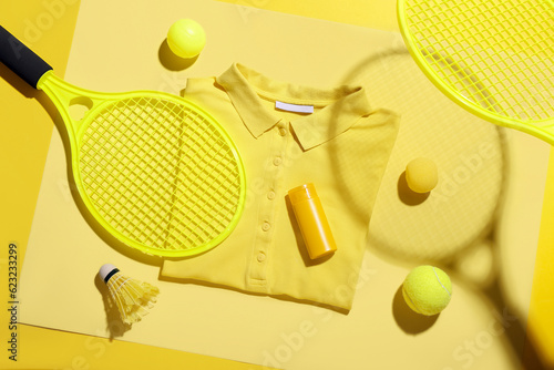 Composition with stylish t-shirt, bottle of sunscreen cream and sports equipment on color background