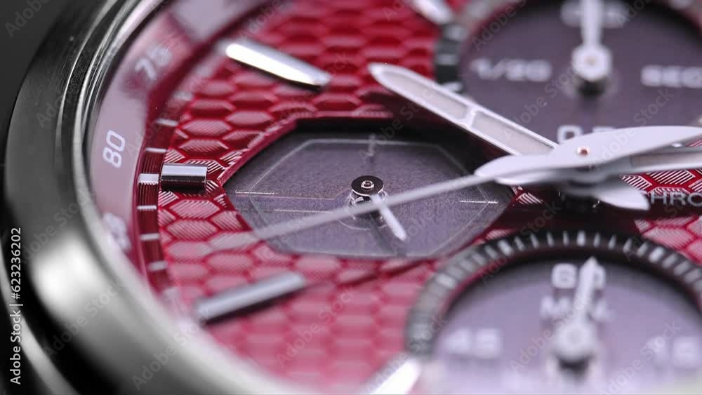Close Up Of Stylish Man Wrist Watch With Moving Hand And Multiple Dials. Men's chronograph watch in metal with sapphire crystal. closeup view of rotating watch, running second arrow. red watch dial Close Up Of Stylish Man Wrist Watch With Moving Hand And Multiple Dials. Men's chronograph watch in metal with sapphire crystal. closeup view of rotating watch, running second arrow. red watch dial