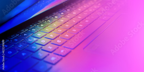 Obraz na plátně Laptop keyboard with vibrant hues illuminating the keys, wallpaper with colorful