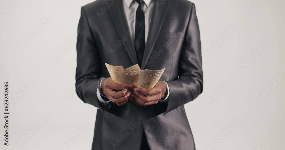 African man advocate for financial independence counts dollars conveys message of taking control of finances making sound financial decisions, and working towards personal wealth and stability. African man advocate for financial independence counts dollars conveys message of taking control of finances making sound financial decisions, and working towards personal wealth and stability.