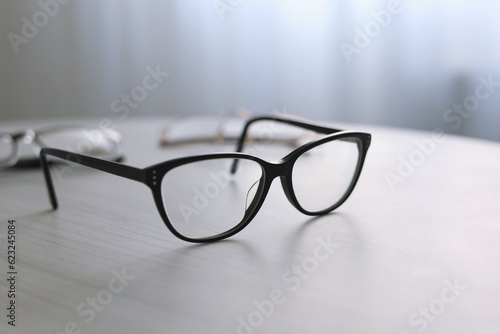 glasses for vision correction on a table in the interior of the room 