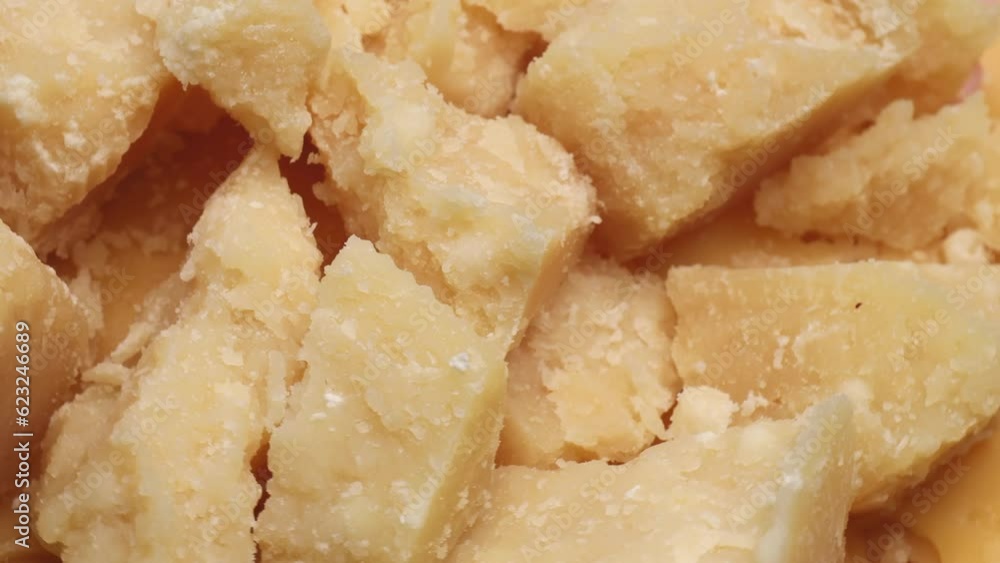 cheese parmesan pieces, rotation in circle. Italian aged hard cheese, Turning cheese parmesan pieces, rotation in circle. Italian aged hard cheese, Turning