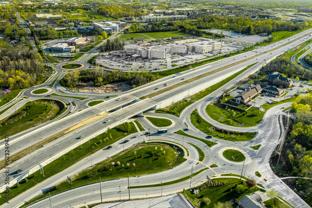 A drone view of a group of roundabouts and a highway