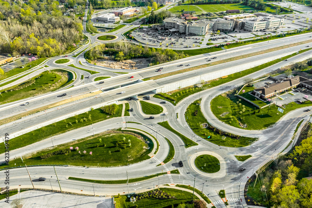 A drone view of a group of roundabouts and a highway