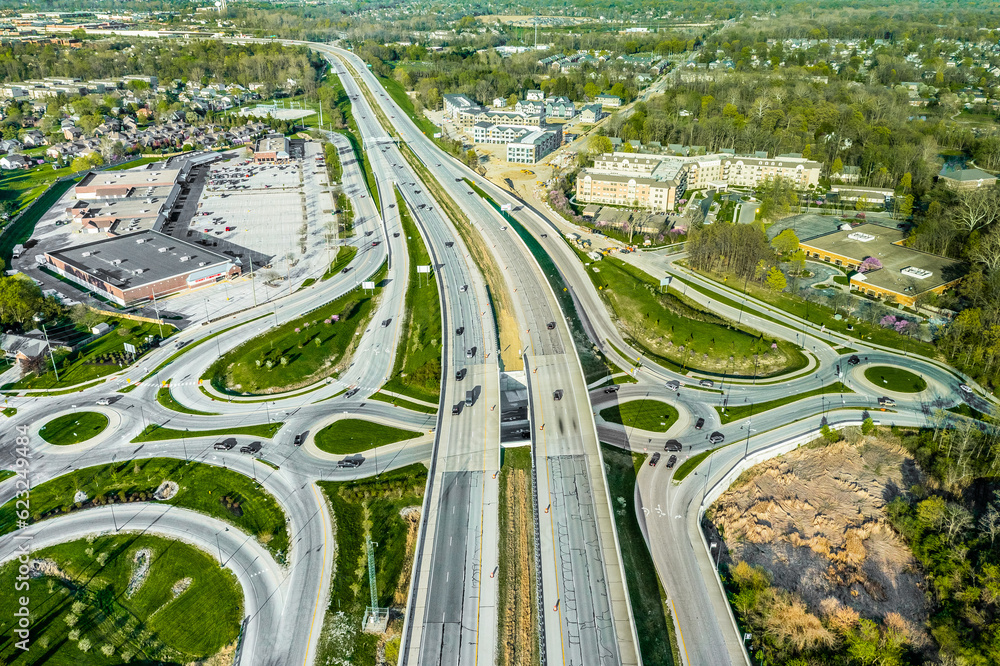 A drone view of a group of roundabouts and a highway A drone view of a group of roundabouts and a highway