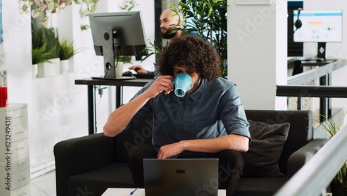 Startup manager making presentation on laptop in business coworking space. Middle eastern entrepreneur checking data statistics to create financial report and solve new task. Tripod shot.