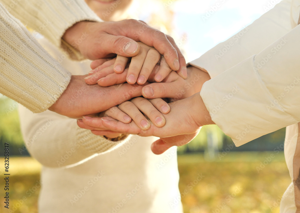 Close up of three Caucasian person stack their palms. Father, mother and son holding their hands together. Gesture sign of support and love, unity togetherness relative people concept Close up of three Caucasian person stack their palms. Father, mother and son holding their hands together. Gesture sign of support and love, unity togetherness relative people concept