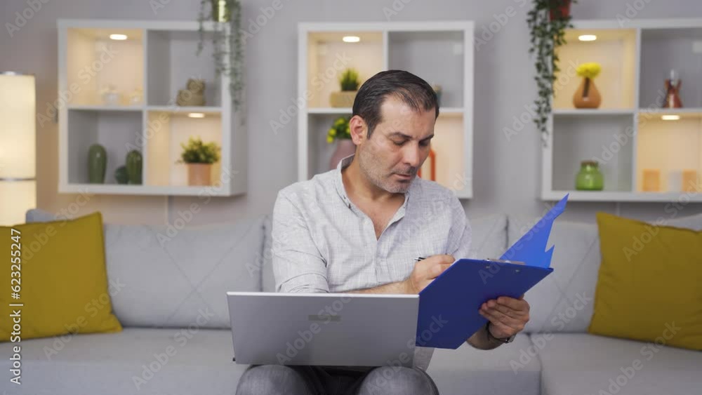 The man examining the files approves the files with his head. The man examining the files approves the files with his head.