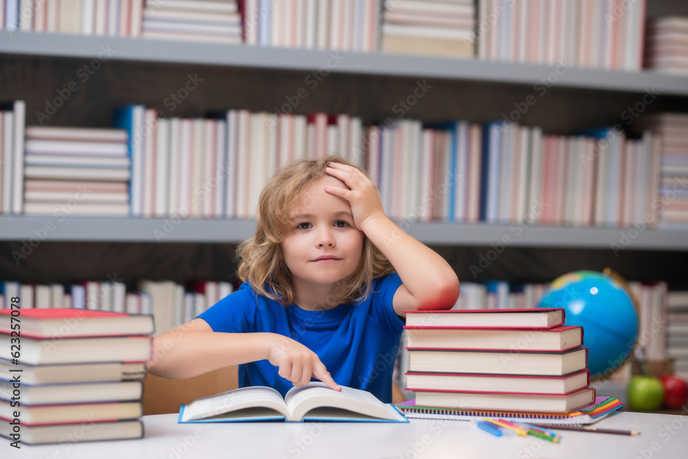 Knowledge and education school concept. School boy pupil reading book in library. Kids learn to read. Child reading books in a book store. Knowledge and education school concept. School boy pupil reading book in library. Kids learn to read. Child reading books in a book store.