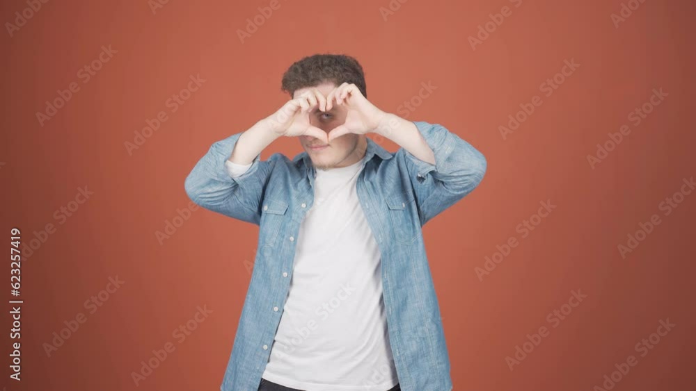 Man making heart sign at camera. Man making heart sign at camera.