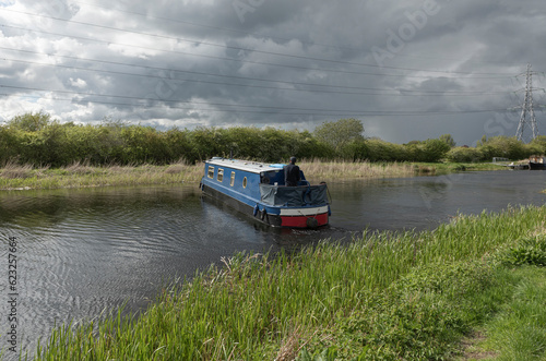 Long house boat turning around on a canal