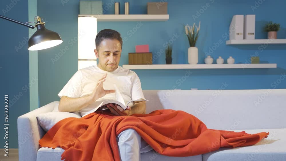 Man reading a book while lying down. Man reading a book while lying down.