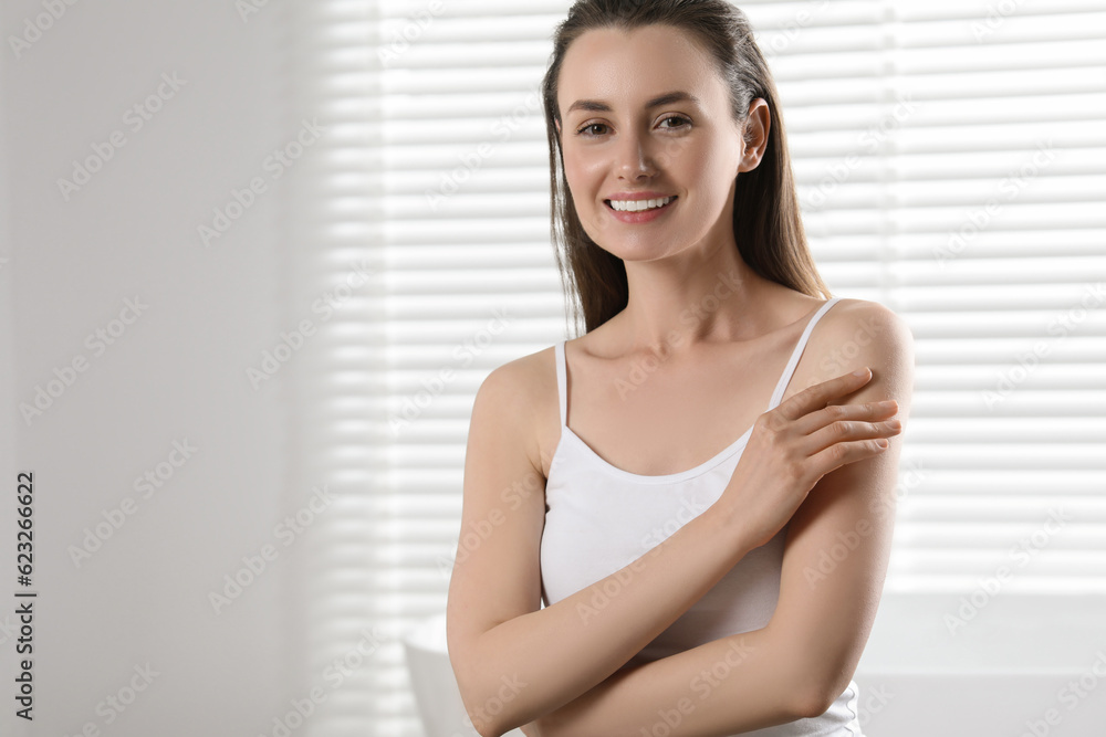 Happy woman with smooth skin indoors, space for text Happy woman with smooth skin indoors, space for text