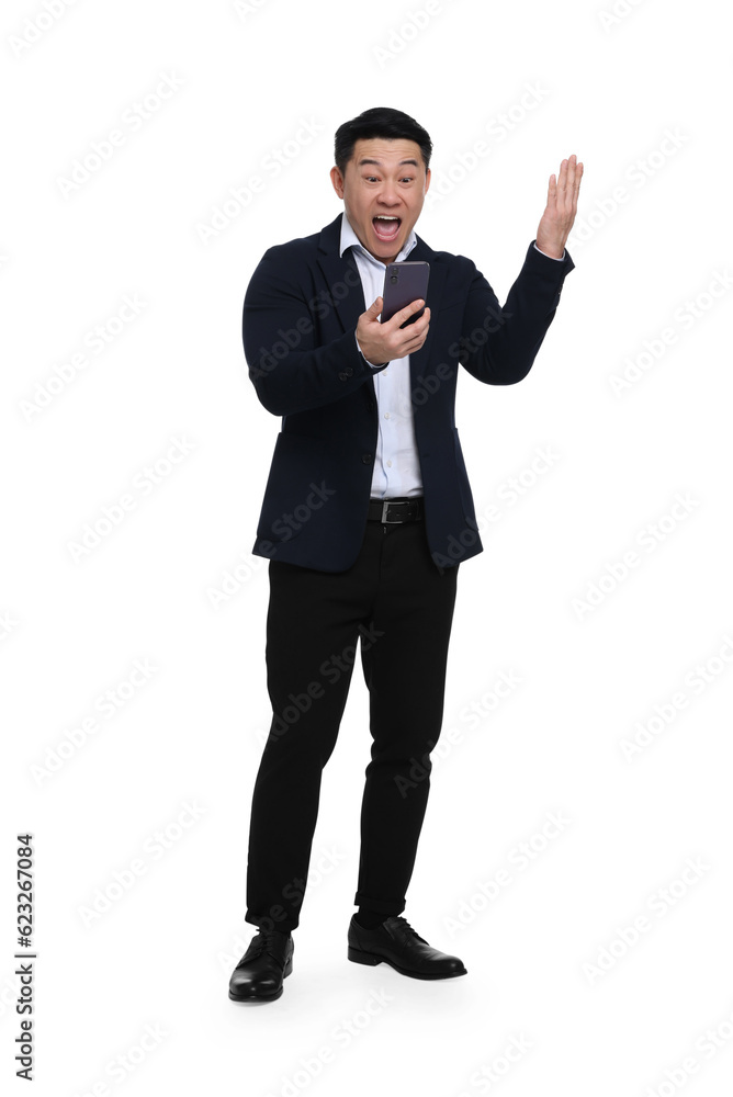 Shocked businessman in suit with smartphone on white background Shocked businessman in suit with smartphone on white background