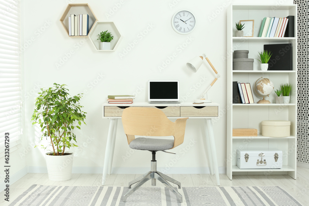 Beautiful workplace with comfortable desk and chair at home