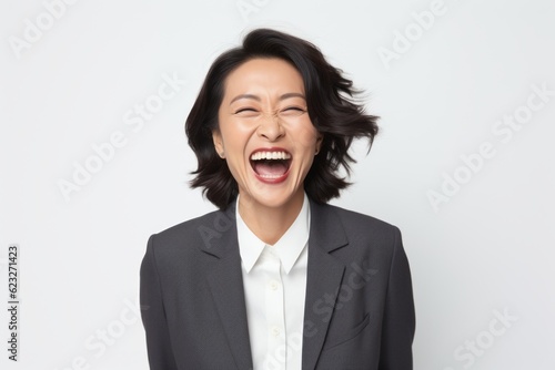 Portrait of an excited businesswoman laughing isolated on a white background