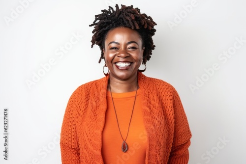 Medium shot portrait photography of a pleased Nigerian black woman in her 40s wearing a chic cardigan against a white background 
