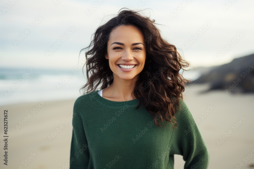Portrait of smiling young woman standing on the beach at the day time Portrait of smiling young woman standing on the beach at the day time