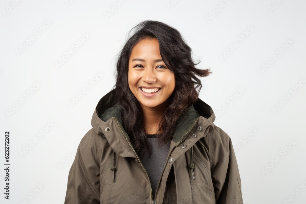 Portrait of a smiling young woman in winter jacket over white background Portrait of a smiling young woman in winter jacket over white background