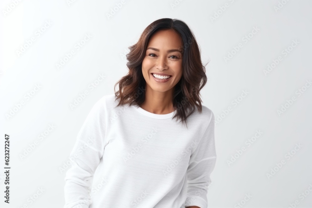 Portrait of a happy young asian woman standing against white background