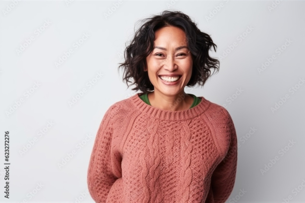 Portrait of a smiling woman in sweater looking at camera isolated on a white background Portrait of a smiling woman in sweater looking at camera isolated on a white background