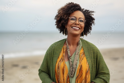 Portrait of a smiling african american woman wearing glasses on the beach