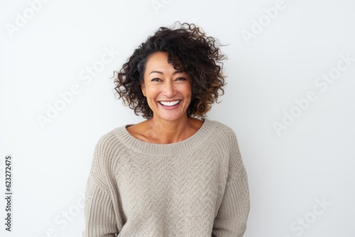 Portrait of a smiling young woman with curly hair against white background