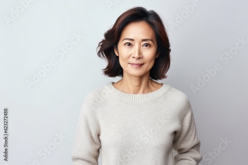 Portrait of a middle-aged asian woman on white background