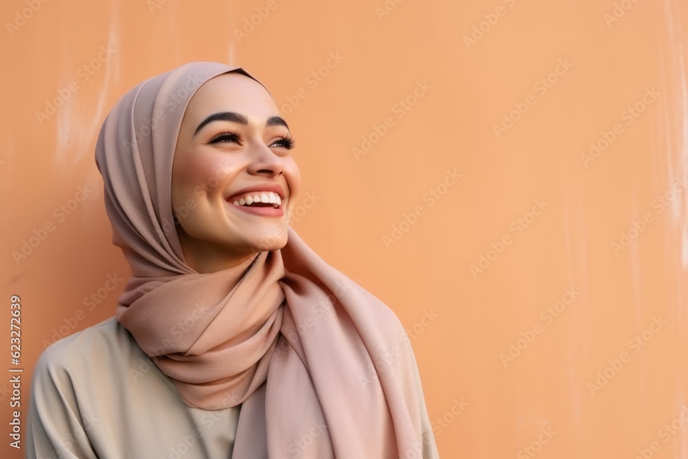 Portrait of a beautiful young muslim woman with hijab smiling. Portrait of a beautiful young muslim woman with hijab smiling.