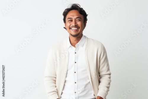 Portrait of a happy young asian man smiling at camera isolated over white background