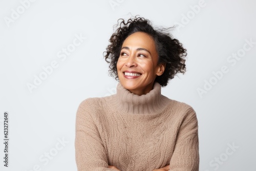 Portrait of a smiling african american woman looking away over white background