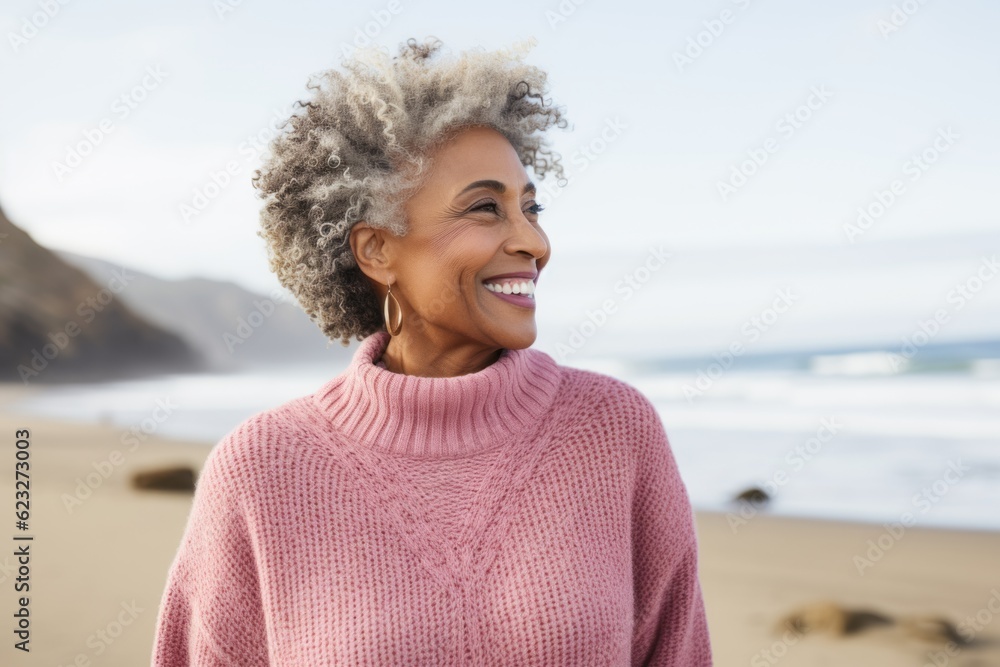 Front view of a smiling young woman with afro hair at the beach Front view of a smiling young woman with afro hair at the beach