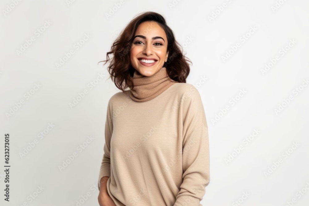 Portrait of a beautiful young woman in a sweater on a white background