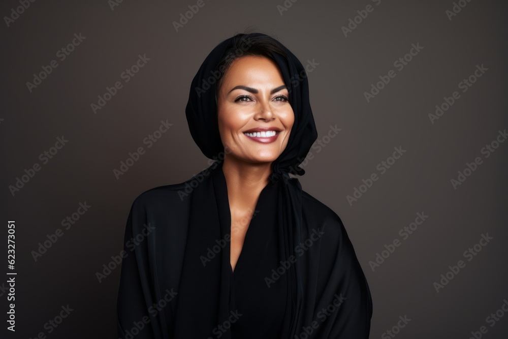 Fototapeta premium Portrait of a beautiful woman in a turban and black dress