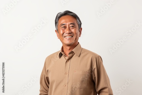 Portrait of a happy senior asian man smiling on white background
